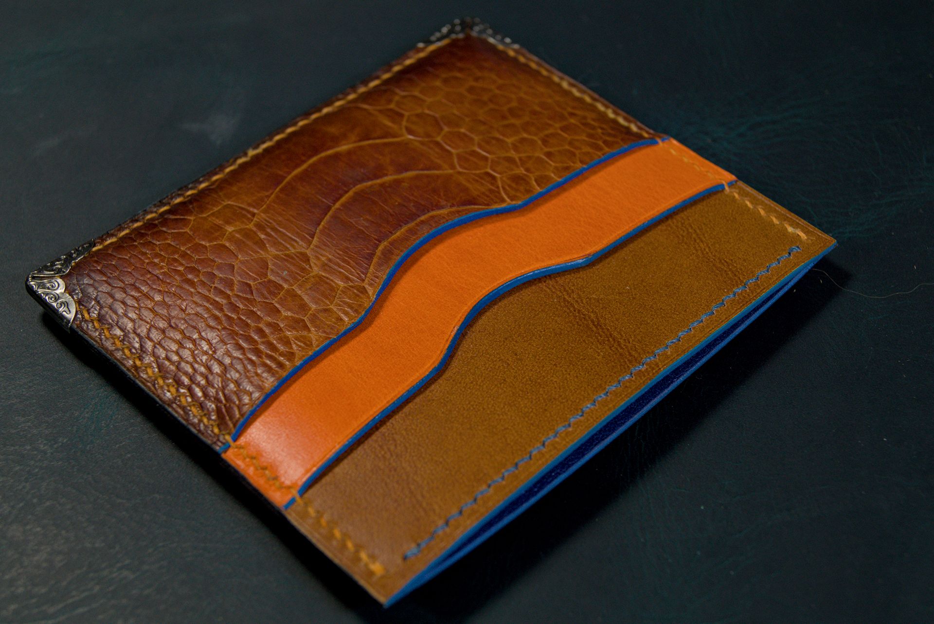 Wallet with burnished edges made from Conceria Walpier Buttero with painted edges and an ostrich leather pocket